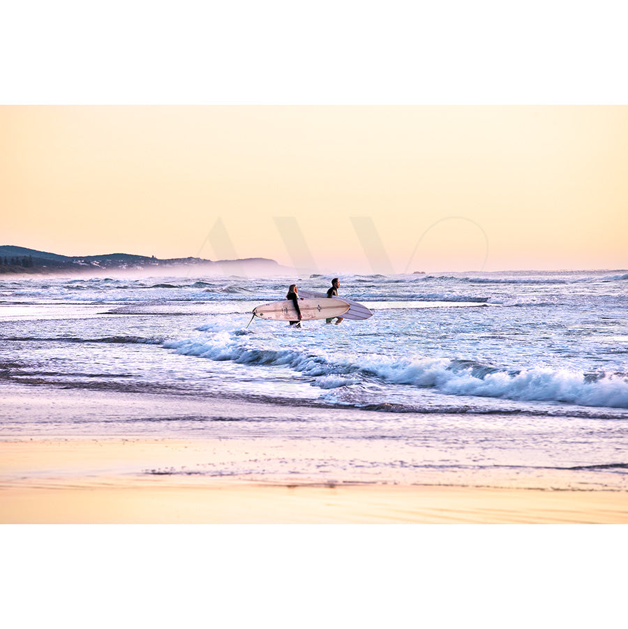 In Coolum Beach Surfers Image 9042 by AWP Image Library, two surfers head into the ocean with their boards at sunrise, amidst gentle waves and a pastel sky that cast a serene ambiance over Coolum Beach.