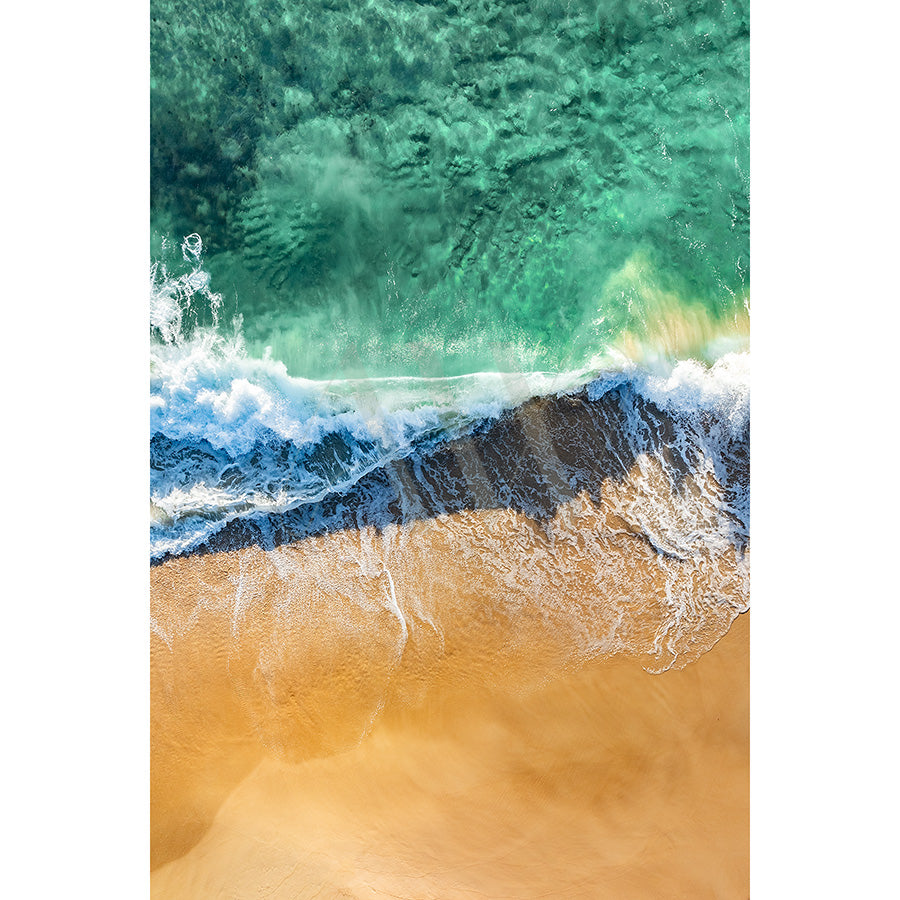 The AWP Image Librarys Coolum Beach Drone Image 0160 captures turquoise waves meeting golden sand, with clear waters revealing underwater formations and white foam lining the serene coastal landscape.