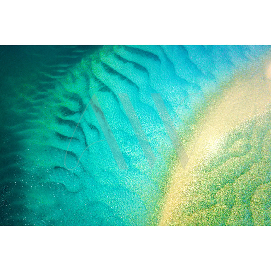 The Noosa Drone Image 2132 by AWP Image Library beautifully captures the vibrant blues and greens of the ocean with sandbars along the Noosa River, where light and dark patterns resemble waves or currents, evoking tranquility and natural beauty.