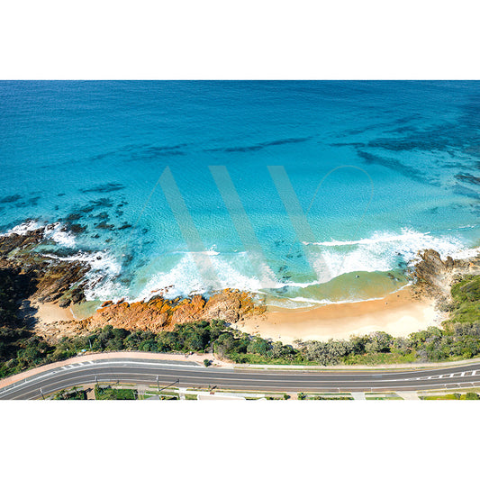 The Coolum Beach Drone Image 1645 by AWP Image Library showcases turquoise waves, rocky cliffs, lush greenery, a sandy beach, and a coastal road running parallel to scenic bays.