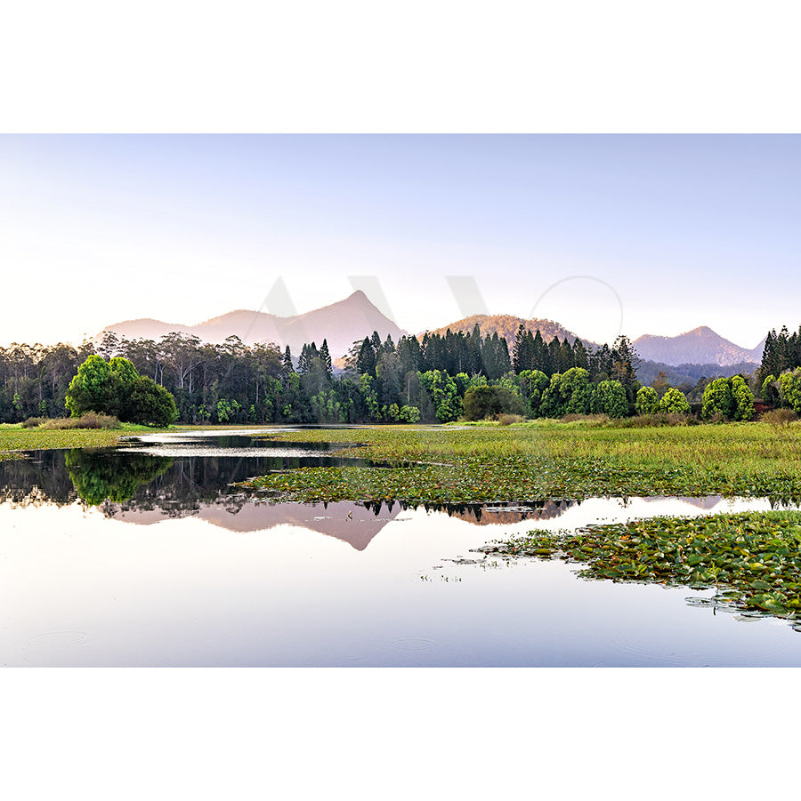 Doon Doon Creek Image 6318 by AWP Image Library captures a tranquil lake bordered by lush greenery, reflecting mountains and a clear sky—perfect for nature lovers seeking peace near Doon Doon Creek.